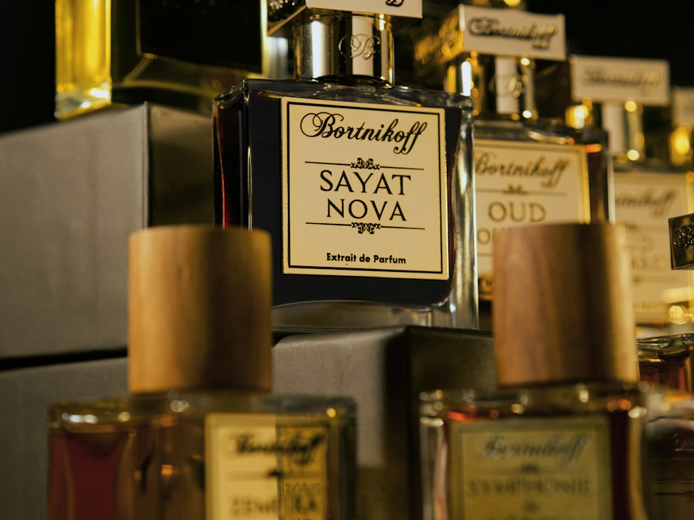 Lit retail shelves inside a duty-free store, stocked with fragrance and spirits boxes